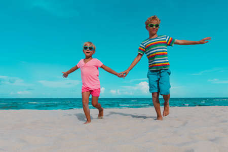 happy kids enjoy beach vacation, boy and girl have funの写真素材