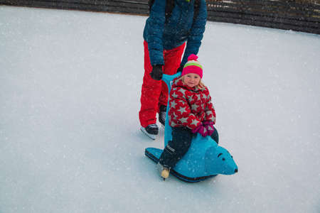 father with little daughter skating in winter, family sportの写真素材