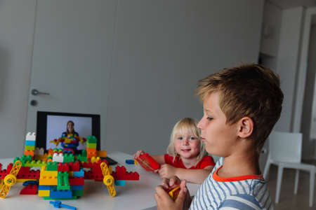 kids playing with constructor at home during online lesson. Remote learning.の写真素材