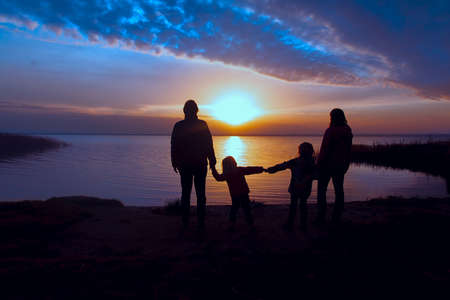 family with kids at sunset, mom, dad and kids enjoy natureの写真素材