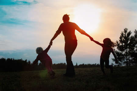 happy mother with kids play in natureの写真素材