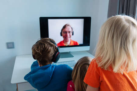 family and social distancing. father talking to kids onlineの写真素材