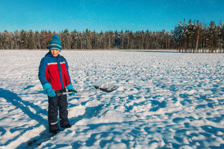 kid dig and clean winter snow, family winter activitiesの写真素材
