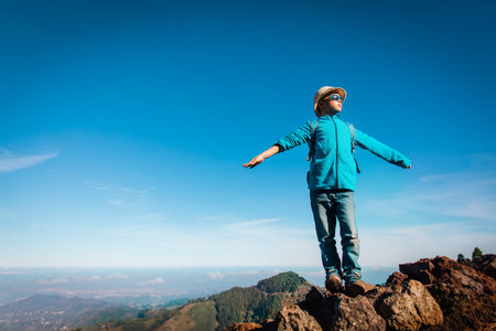 happy boy hiking in nature, kid travel in mountainsの写真素材