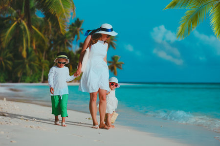 mother with kids on tropical beach vacationの写真素材