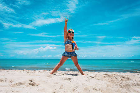 cute little girl with suncream on beach, sun protection conceptの写真素材