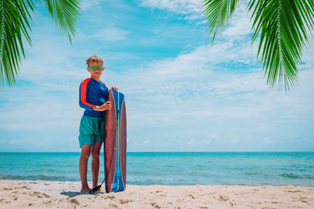 Preteen boy surfing on tropical beach .Active water sports for kids.の写真素材