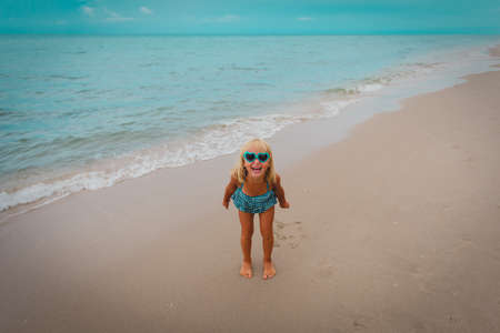 happy cute little girl on beach vacationの写真素材