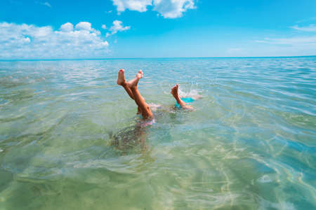 kids making handstand in sea, family sea funの写真素材