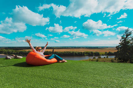 happy kid with laptop enjoy vacation in nature, remote learning and internet for kidsの写真素材