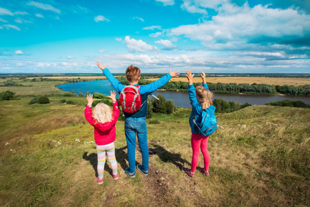 happy kids travel in nature, boy and girls enjoy scenic viewの写真素材