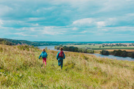 happy kids play in nature, boy and girl travel, family vacation in natureの写真素材