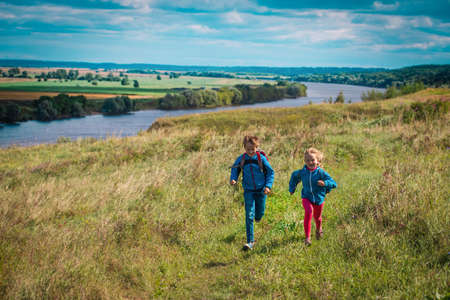 happy kids play in nature, boy and girl travel, family vacation in natureの写真素材