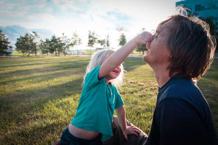 happy father and little daughter playing in sunset nature. Family weekendの写真素材