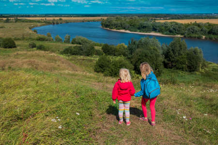 kids travel in nature, little girls enjoy scenic viewの写真素材