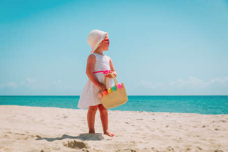 happy cute girl with big bag on beach vacationの写真素材