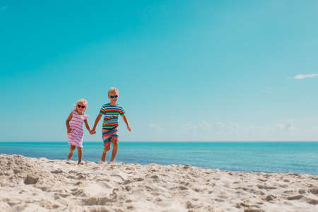 kids run, boy and girl have fun on tropical beachの写真素材