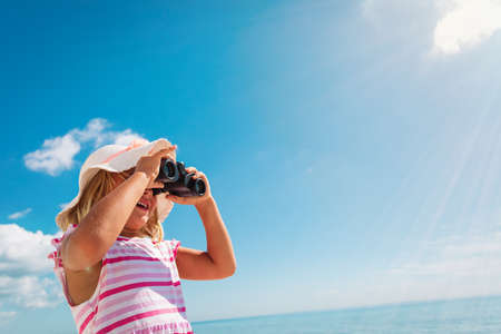 happy cute little girl travel on beachの写真素材