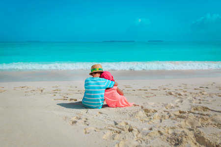 happy boy and girl hug on beach vacationの写真素材