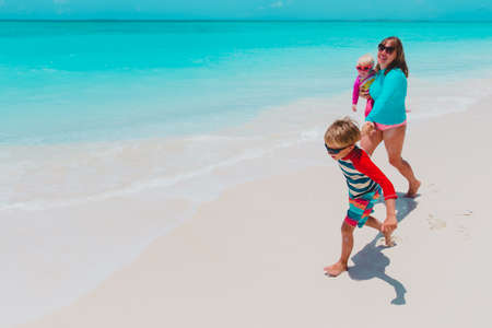 happy mother and kids enjoy beach vacation, family have funの写真素材