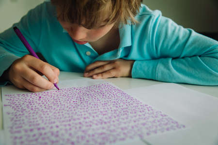 kid writing and learning numbers, autism or asperger syndrome, mental health issuesの写真素材