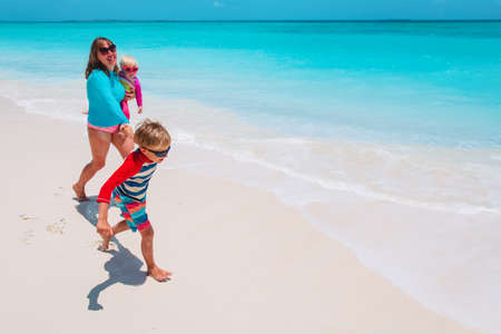happy mother and kids enjoy beach vacation, family have funの写真素材