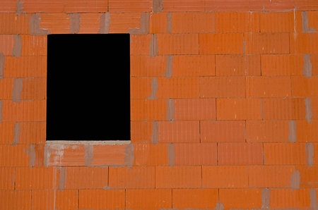 new brick wall with a windowの写真素材