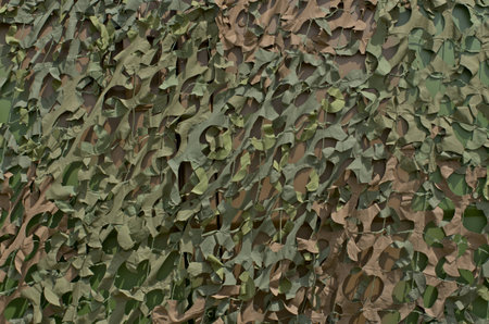 camouflage grid hiding a military vehicleの写真素材