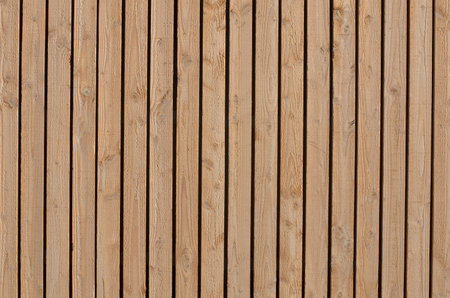wood boards arranged vertically with space between themの写真素材