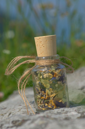 glass bottle with  dried mountain herbsの写真素材