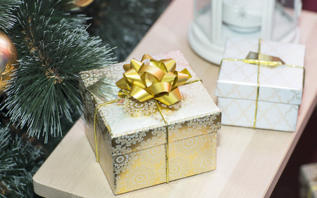 Christmas tree and gifts. Gifts are on the table near the tree.の写真素材