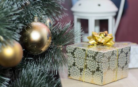 Christmas tree and gifts. Gifts are on the table near the tree.の写真素材