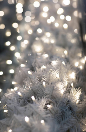Christmas garland, bokeh. The glowing garland on a branch of a tree.の写真素材