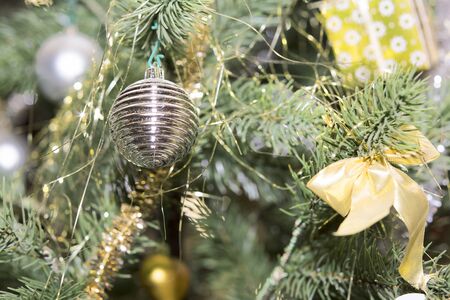 Christmas decorations hang on the Christmas tree. Christmas tree decorated with toys.の写真素材