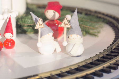 Christmas decorations. Wooden snowmen with signs that are near the train tracks.の写真素材