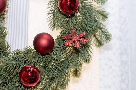 Wreath decorated with toys. Christmas wreath with baubles and the snowflake.の写真素材