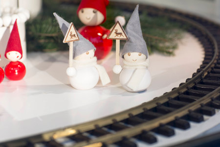 Christmas decorations. Wooden snowmen with signs that are near the train tracks.の写真素材