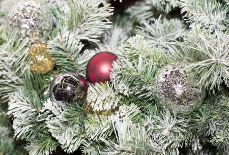 Christmas tree decorated with toys. Colored balls hanging on a branch of a Christmas tree.の写真素材