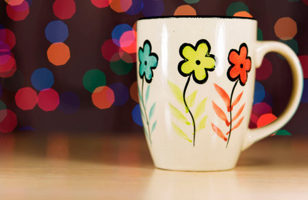 Tea mug on the background bokeh. Ceramic mug stands on the table.の写真素材