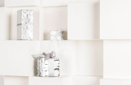 Three gift box standing on a white shelf. Gift box on a white background.の写真素材