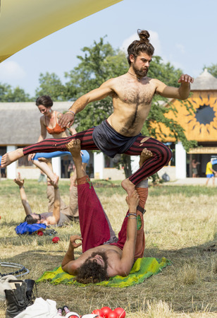 Ozora, Hungary - August 4, 2015: Ozora Festival, one of the greatest music gathering in Europe. Music festival in Hungary. Male actors train next to a circus tent.のeditorial素材