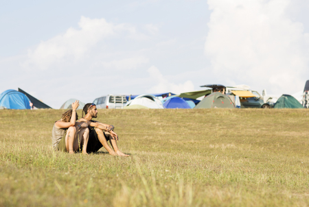 Ozora, Hungary - August 4, 2015: Ozora Festival, one of the greatest music gathering in Europe. Music festival in Hungary. People sit on the hill next to the tents.のeditorial素材