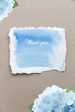 Blue Hydrangea and paper card with space for your text. Decorative background with colored hydrangea flowers, paper for your text congratulations.の写真素材