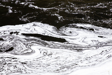 abstract background of black and white oil paint on the water surface