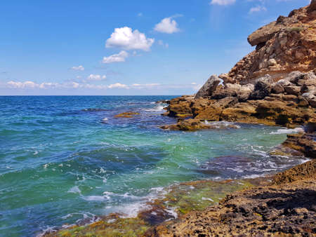 Crimea. The turquoise sea beats against the rocksの写真素材