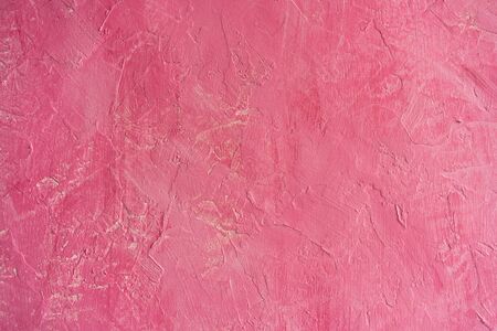 The surface of an old rugged bright pink wall. Background structurの写真素材
