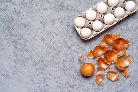 Easter eggs are colored with natural egg dye from fruits and vegetables, eggs are colored with onion husks on a gray background, copy space.の写真素材