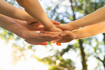 children holding hands, standing on the green grass, the concept of friendship and a group of young...