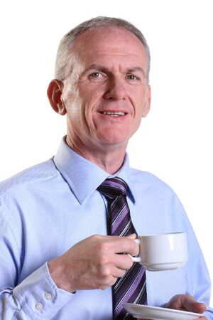 Experienced businessman having a break with a cup of coffeeの写真素材