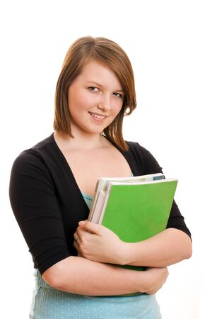 Pretty teenage student holding books  Studio shot, looking at camera, White background with space for copyの写真素材